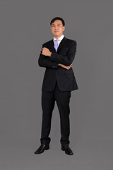 Obraz na płótnie Canvas Portrait of attractive businessman Asian standing against on gray background with copy space and clipping path