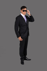 Portrait of attractive businessman Asian standing against on gray background with copy space and clipping path