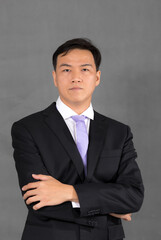 Portrait of attractive businessman Asian standing against on gray background with copy space and clipping path