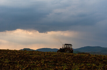 Fototapeta premium tractor working on field outdoor