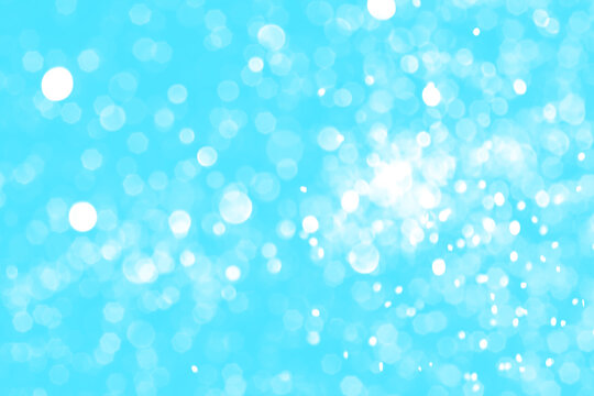 Bright blue sparkling glitter bokeh background, abstract defocused lights texture