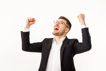 A jubilant businessman white background. A man in a business suit rejoices at success