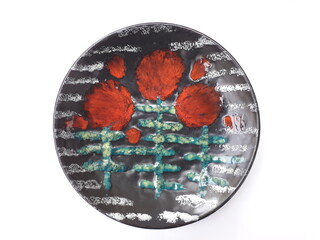 Mid-century modern pottery - black wall plate with red flowers