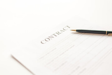 Green ballpoint pen on contract documets in office table