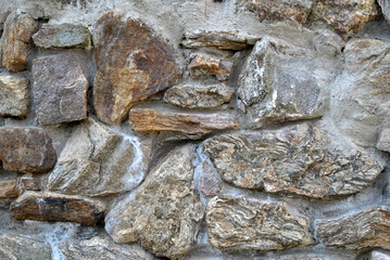 Zdjęcie przedstawiające fragment kamiennego muru - obrazy, fototapety, plakaty