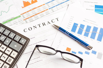 Naklejka na ściany i meble Close-up image of contract and charts form on a desk