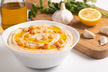 Delicious hummus with chickpeas, olive oil, lemon and pita bread. Vegetarian food concept.