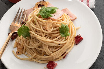Pasta in white plate on wood background Italian food.