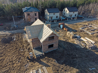 Newly built homes in a residential estate. Construction of the building of brick.
