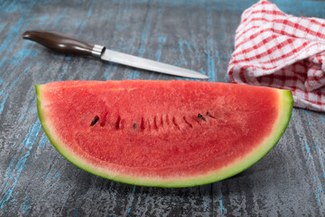 Healthy fruit watermelon slice on black blue table.