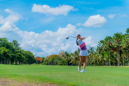 Asian lifestyle girl playing golf on a sunny day on the course