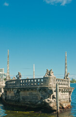 front view, medium distance of a carved stone ship with limestone statue in shallow, tropical water at a state park