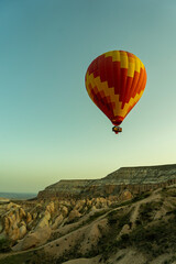 Fototapeta na wymiar Colorful hot air balloon at sunrise over the cave town, Goreme village, Cappadocia, Turkey image. 