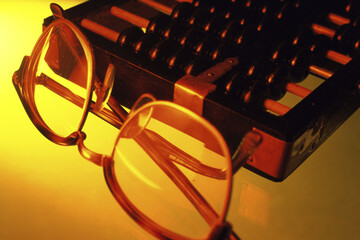 Close-up of eyeglasses near an abacus