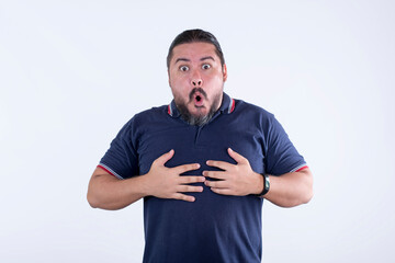 A surprised man in disbelief and awe. Reaction after winning the lotto. Hands on chest. A male of...