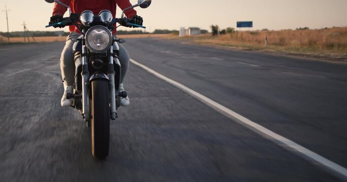 Motorcyclist rides on the road with bumps, you can see the operation of the depreciation system