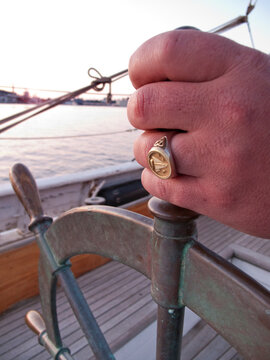 Man at helm of sailboat