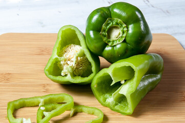 green bell peppers on wooden table