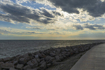 Panoramic view to Adriatic sea with stone seashore on foreground on a sunset