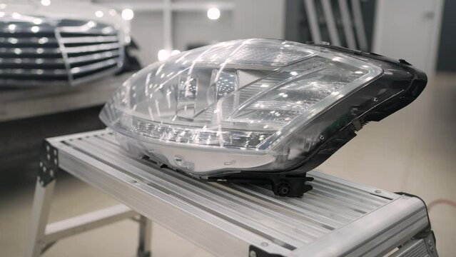 The headlamp of a modern prestigious car from a close angle. Headlight from an expensive car.