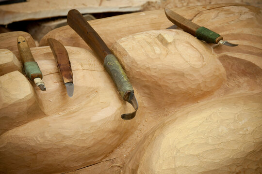 Work tools on a totem pole, Potlatch Totem Park, Ketchikan, Alaska, USA