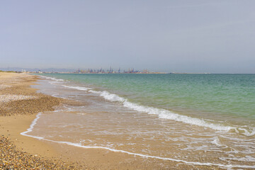 Panoramic view to port of Valencia on Balearic sea from yellow sandy beach
