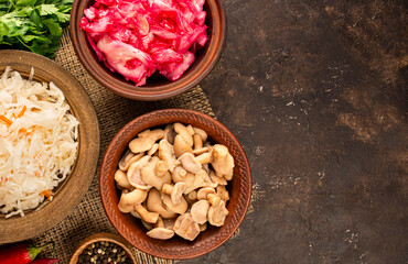 Pickled mushrooms, sauerkraut, cabbage salad with beets on the table.Fermented food. Homemade food. Pickled vegetables. Top view, flat lay. Copy space. Culinary background.