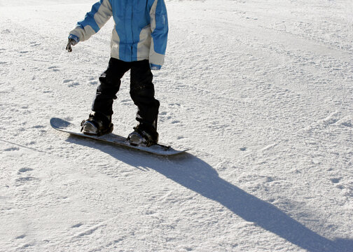 Tourist snowboarding on snow