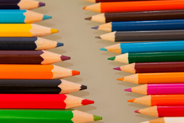 Row of colored pencils with sharp points