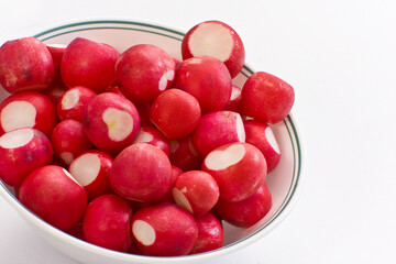 Cleaned Fresh radishes in bowl on white background