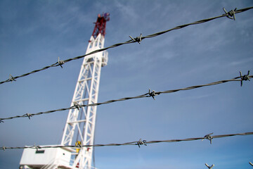 Drilling rig fenced with barbed wire