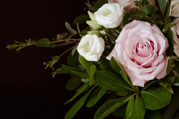 Dramatic Black Background with Romantic Wedding Bouquet with Roses in White and Pink with Gorgeous Deep Green Leaves