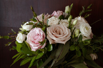Dramatic Black Background with Romantic Wedding Bouquet with Roses in White and Pink with Gorgeous Deep Green Leaves