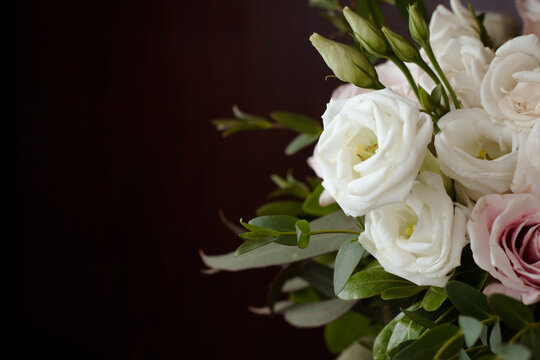 Dramatic Black Background with Romantic Wedding Bouquet with Roses in White and Pink with Gorgeous Deep Green Leaves