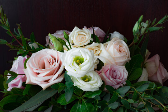 Dramatic Black Background with Romantic Wedding Bouquet with Roses in White and Pink with Gorgeous Deep Green Leaves