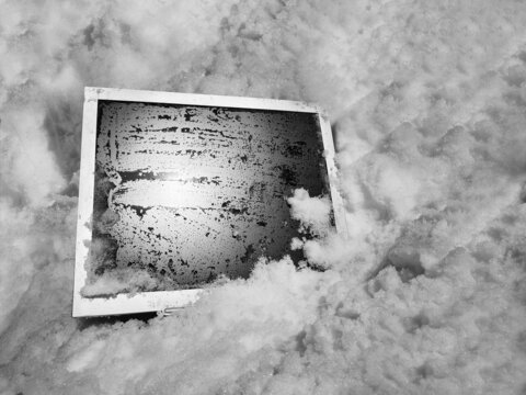 Old computer monitor wet in the snow. Computer technologies of the 21st century. Specialization in IT technologies. Outdated system pc concept.