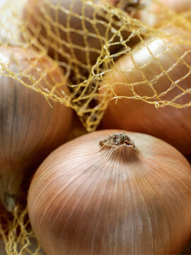 Close up of onions in open net bag