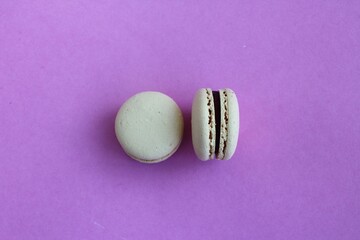 Obraz na płótnie Canvas Two macaroons isolated on a pink background.