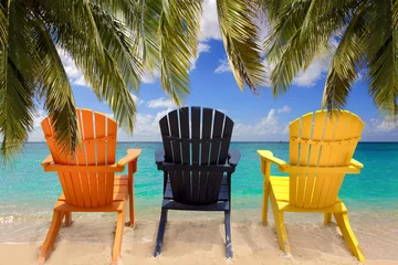 Papier Peint photo autocollant Plage de Seven Mile, Grand Cayman Trois chaises de plage colorées sous des branches de palmier
