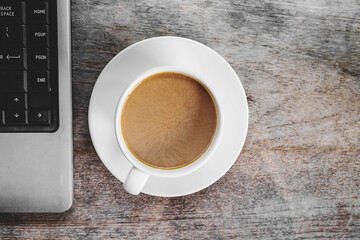 Coffee cups and laptops on the desk