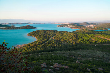 Landscape view of the coast, of the sea azure color with green islands. Seen from Seitan Sofrasi, touristik place in Ayvalik Balikesir, Turkey