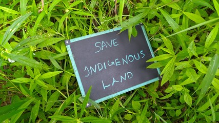 Conceptual protest sign photo of protestors left over isolated black board on thick green grass of...