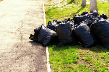 City street cleaning. Garbage in black bags on the streets of the city.