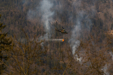 helicopter in flight putting out fire