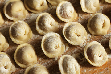 Homemade meat dumplings. russian pelmeni in wooden table.