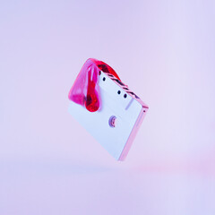 Flying or levitate retro vintage cassette tape with red glitter slime.  Minimal cyberwave or...