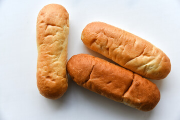 Three hot dog buns on a plate