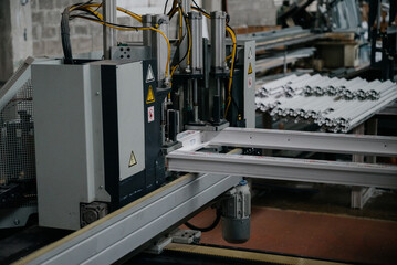 Factory for aluminum and PVC windows and doors production. Details industrial equipment.
