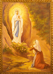 MONOPOLI, ITALY - MARCH 6, 2022: The painting of Appearance of Virgin Masry to st. Bernadette in Lourdes  in the church Chiesa di San Franceso d Assisi by A. Nicolas (1932).