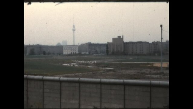 East Berlin from the Wall 1970 - Panning view of Potsdamer Platz and the Fernsehturm Tower in East Berlin from a viewing platform in West Berlin, on the other side of the Berlin Wall, in 1970.  